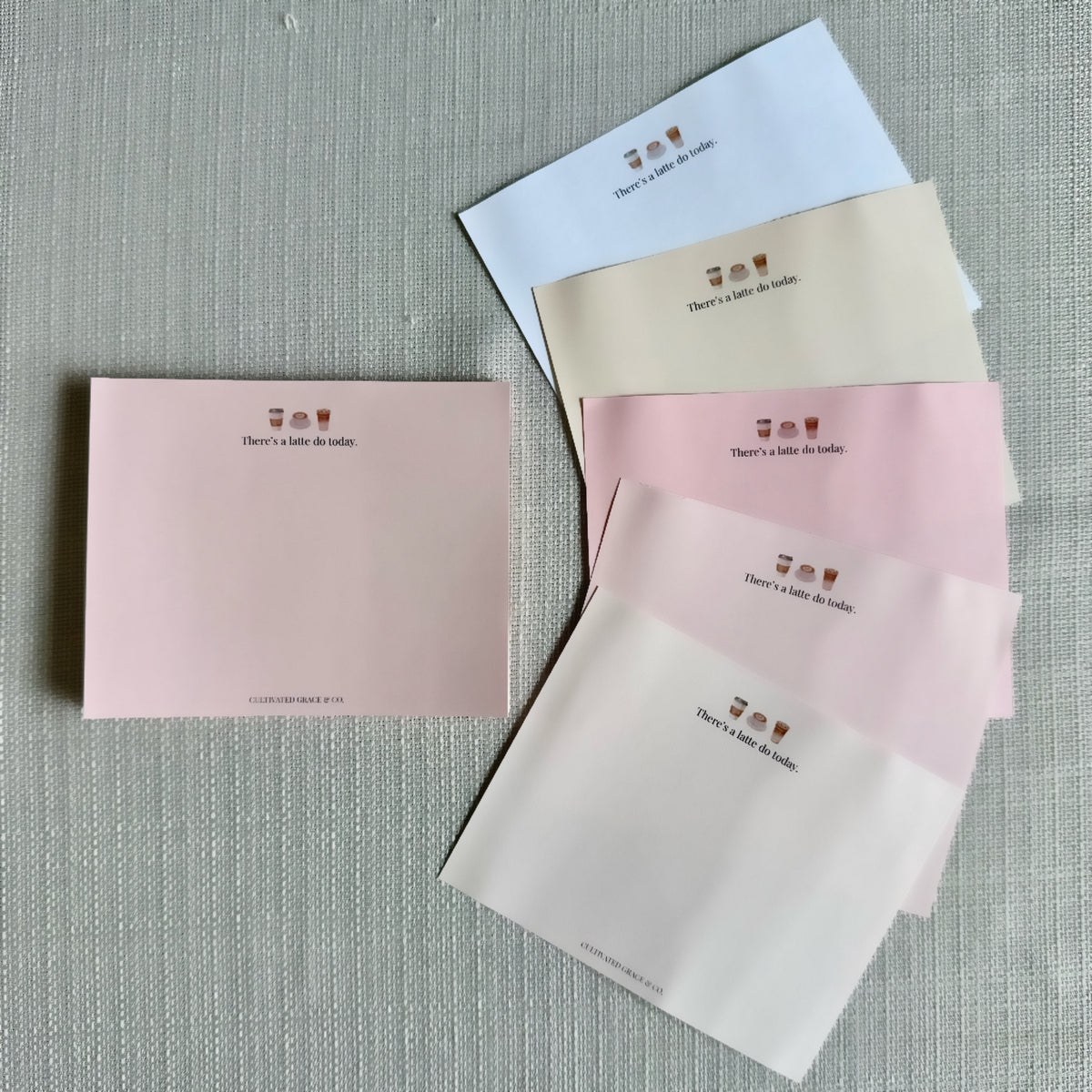 There's a Latte Do Today notepad sheets fanned out to show the alternating pink paper shades