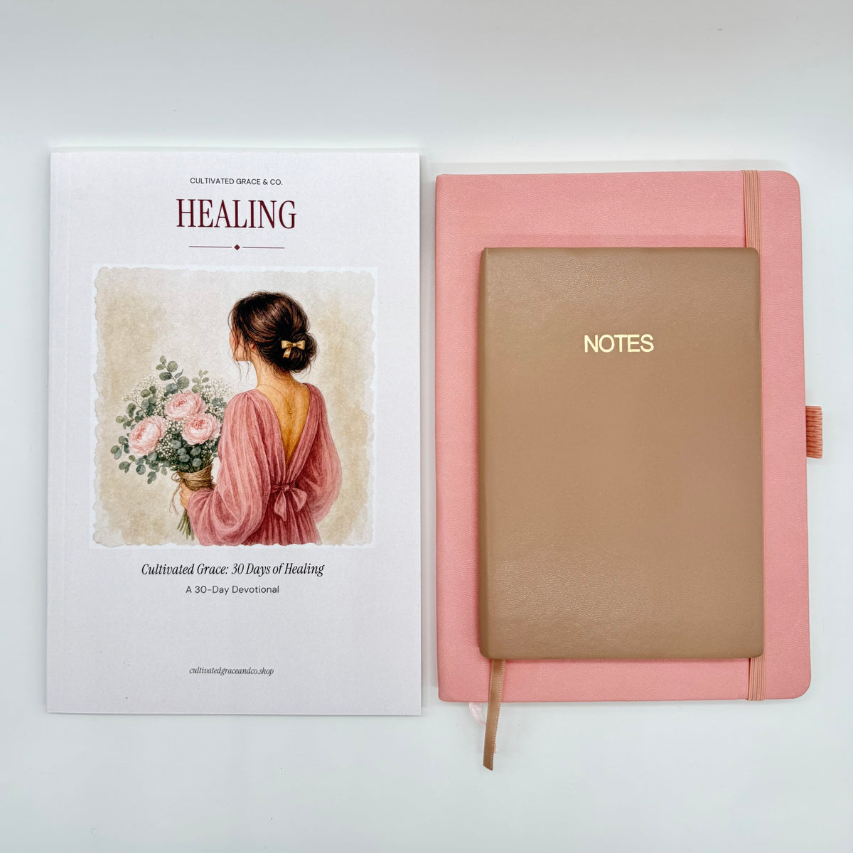 Cultivated Grace 30 Days of Healing devotional beside a blush hardcover Notes journal