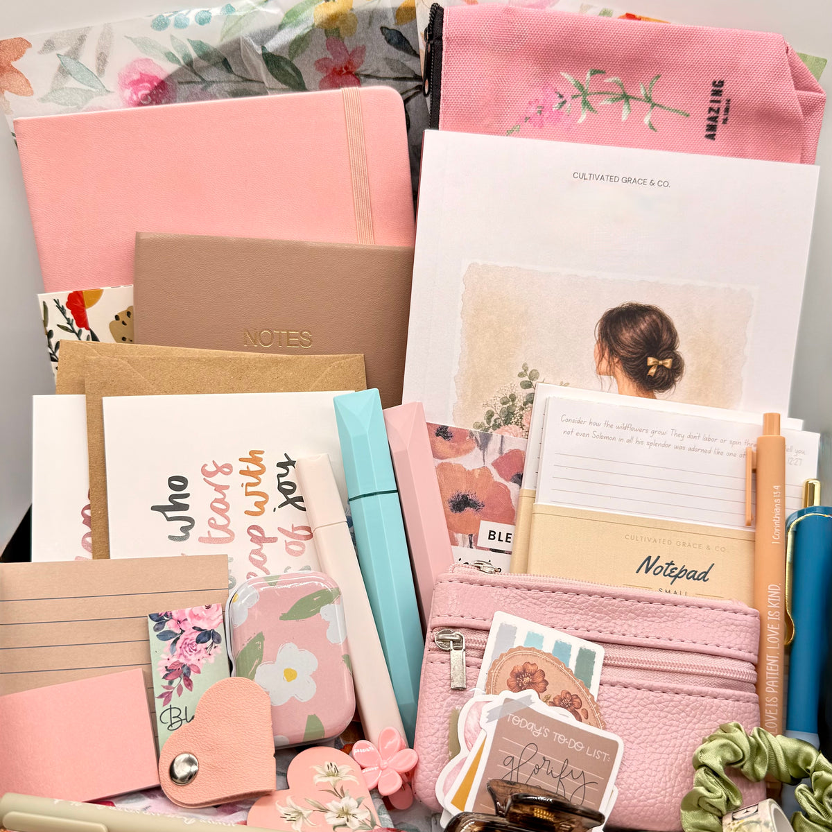 Overflowing crate of Cultivated Grace stationery, journals, notepads, pens and a 30-Day Devotional from The Devotional Box