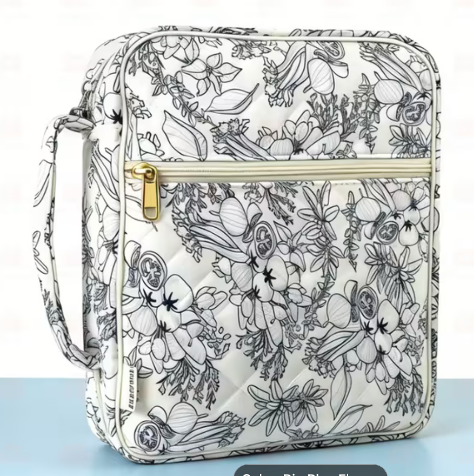 Bible carrying case in a black and white line-art floral quilted pattern with gold zip pulls and carry handle