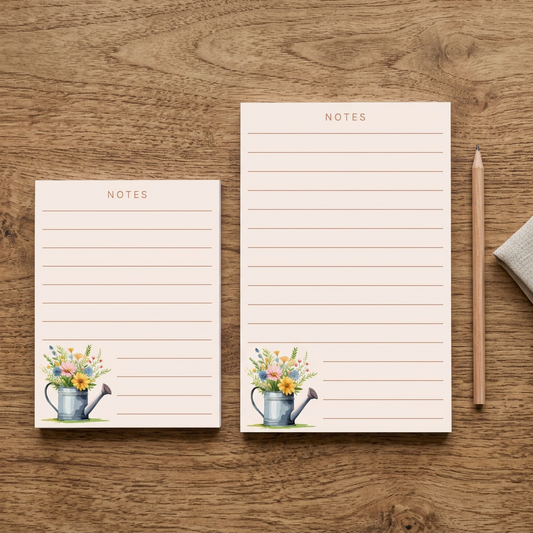 Both notepad sizes styled on a rustic wood table