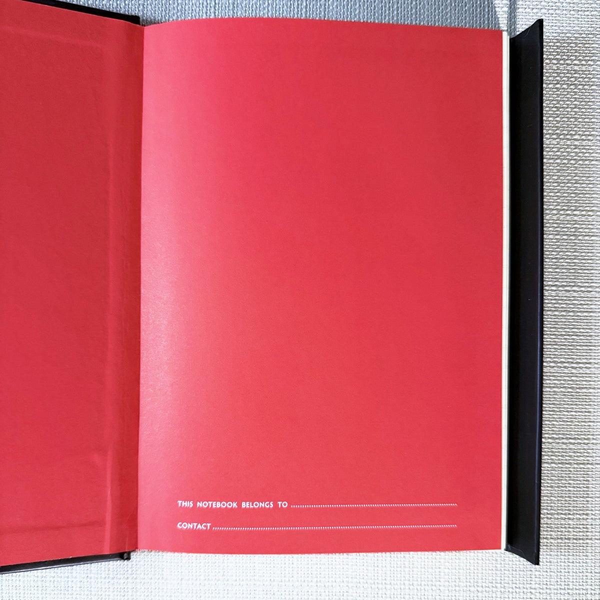 Inside cover of the black bee journal with a name and contact page.