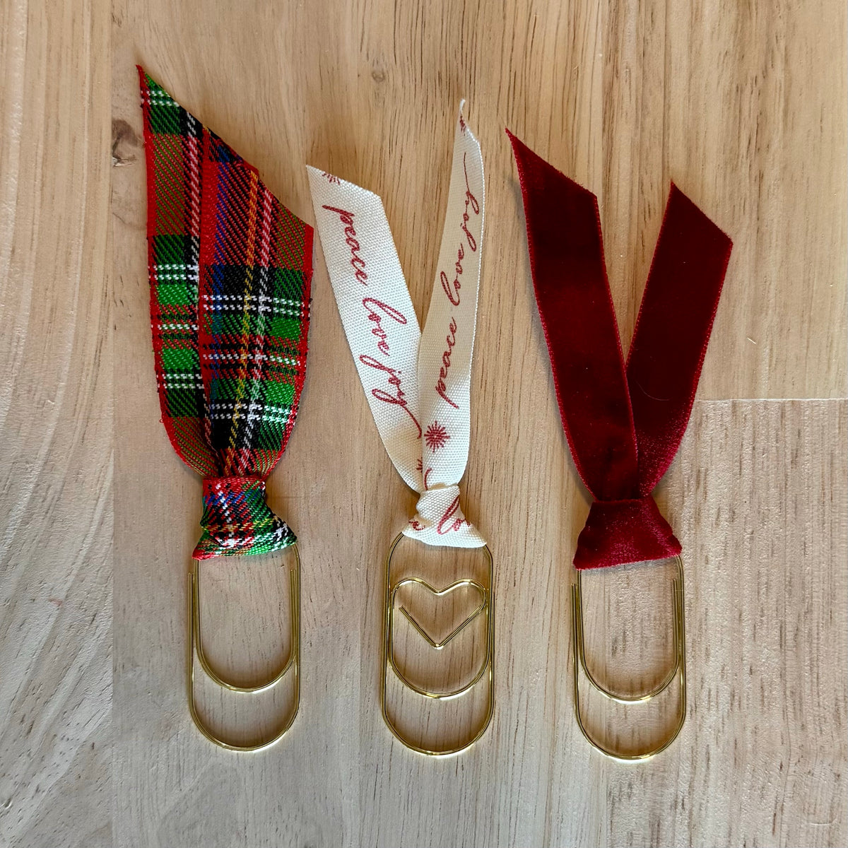 Christmas Red example set of 3 ribbon paperclip bookmarks: red plaid, cream "peace love joy" and burgundy ribbons. Ribbons in your set will vary.