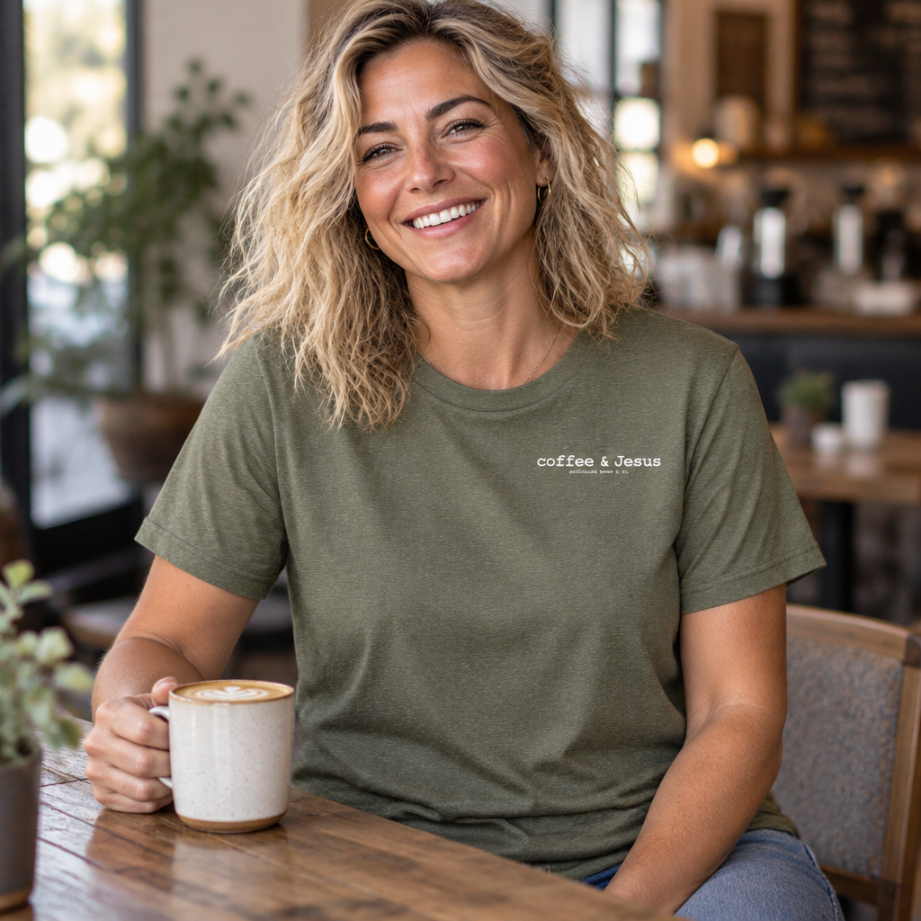 Coffee & Jesus Softstyle tee in Heather Military Green, worn at a café table