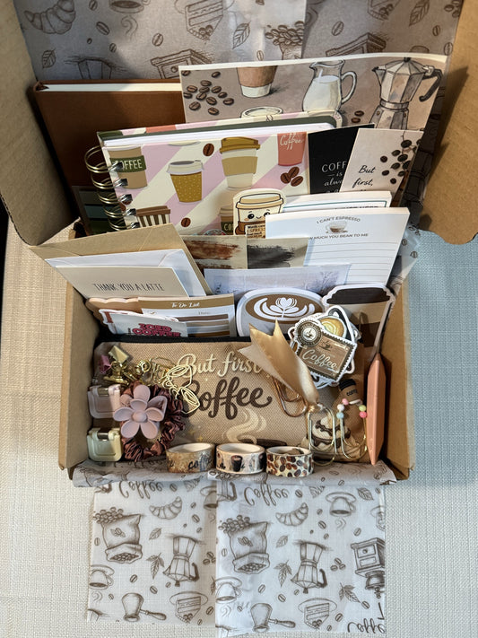 The Coffee Lover Box packed and ready to ship, coffee-print journals, notepads, pouch and paper goods layered inside the mailer