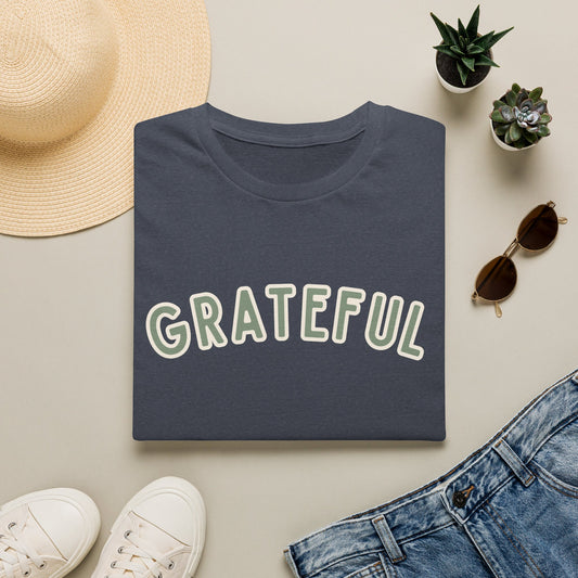 Grateful Softstyle T-Shirt in Heather Navy, sage green arched GRATEFUL lettering with cream outline, folded flat lay
