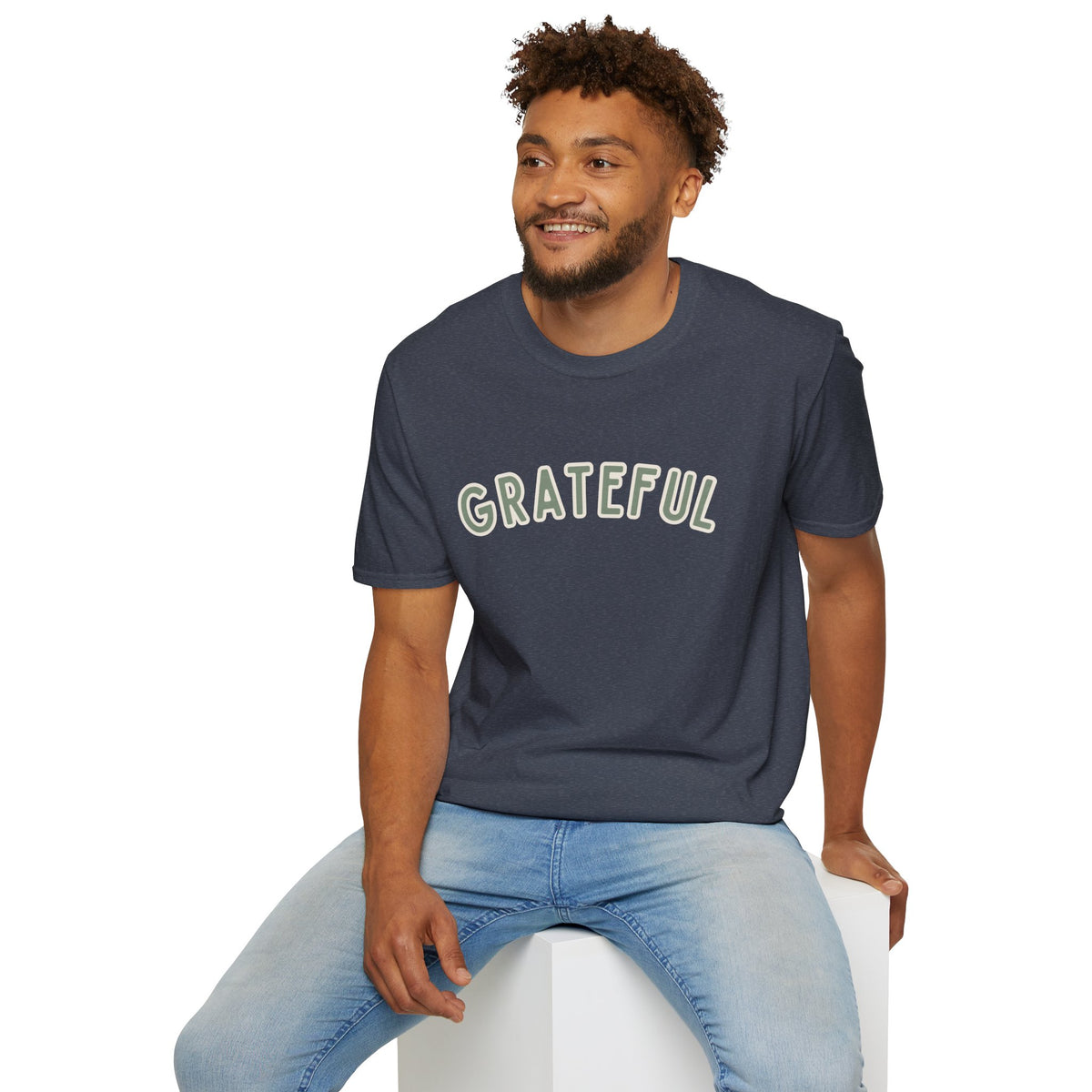 Grateful Softstyle T-Shirt in Heather Navy, sage green arched GRATEFUL lettering with cream outline, worn by a man