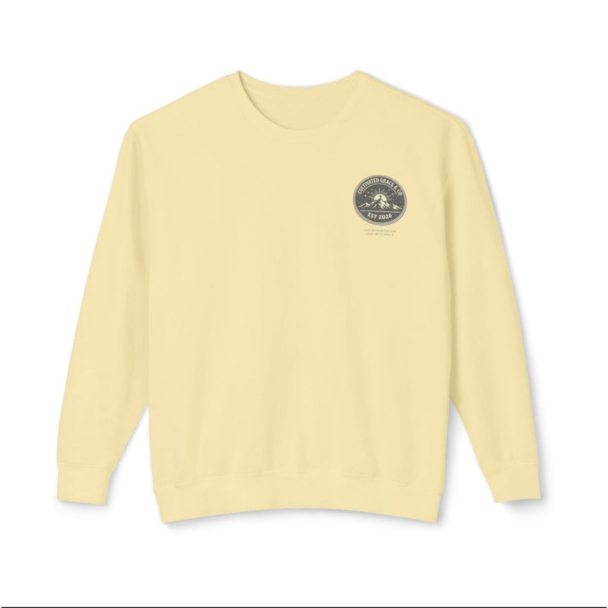 Cultivated Grace & Co. mountains and cross crewneck sweatshirt in Butter, front with left-chest badge