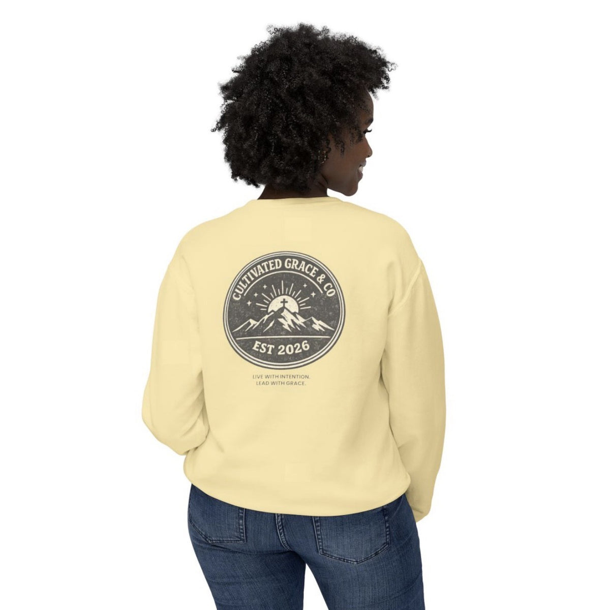 Cultivated Grace & Co. mountains and cross crewneck sweatshirt in Butter, worn, back view