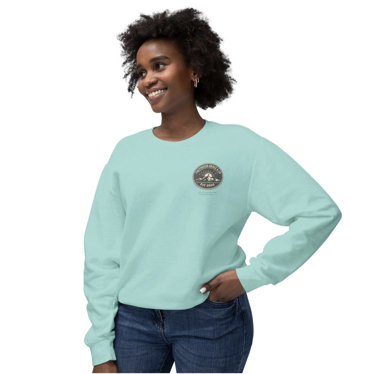 Cultivated Grace & Co. mountains and cross crewneck sweatshirt in Chalky Mint, worn, front view