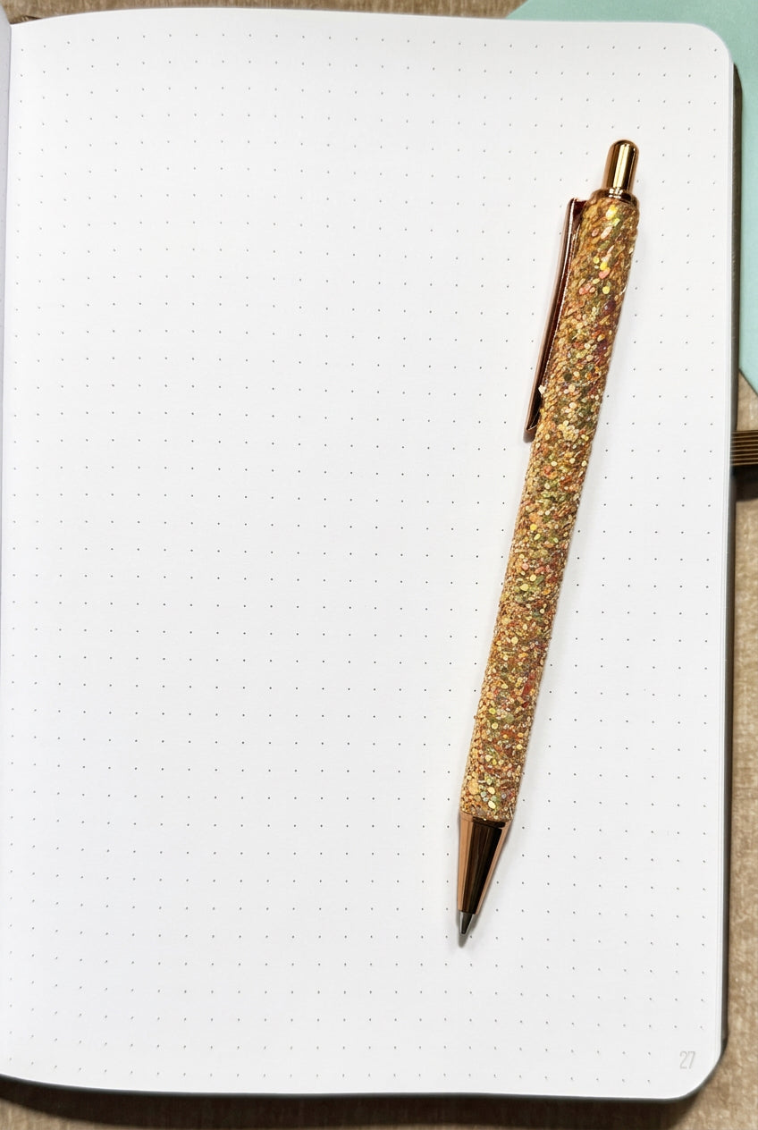 Dot grid pages inside the deluxe print style faith word journal, shown with a pen