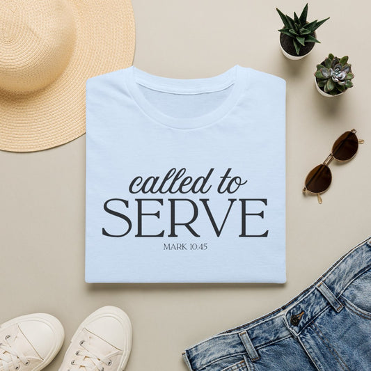Called to Serve tee in Light Blue, folded flat with sun hat, sunglasses and denim